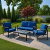 Vista ambientata Set da giardino in alluminio con divano 2 posti, 2 poltrone e tavolino con cuscini blu modello Riviera Totò Piccinni