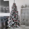 Foto ambientata di un albero di natale stretto realistico innevato verde e bianco decorato streKettinson Slim Xone