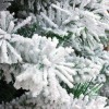Rametti con fiocchi di neve artificiale di un Albero di Natale innevato verde Bianco Berna Totò Piccinni