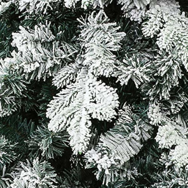 Floccatura su ramo e rametti coperti artificialmente da neve bianca di un albero di natale verde realistico Alaska xone